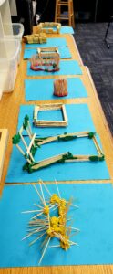 Model homes constructed with straw, sticks, and bricks