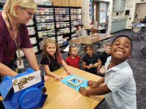 Mrs. Day and her students designing model home from the Three Little Pigs