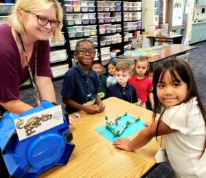 Mrs. Day and her students designing a model home from the Three Little Pigs