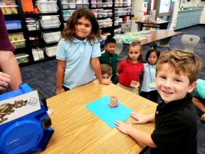Students testing their homes with a blowing machine