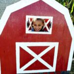 girl and a red barn