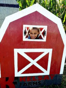 girl and a red barn