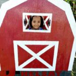 girl with a red barn