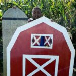 boy with a red barn