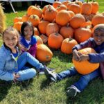 first grade sitting with the pumpkins