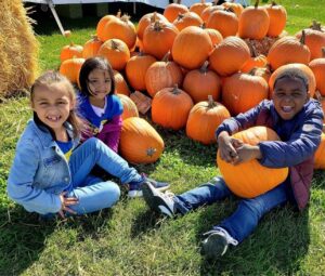 first grade sitting with the pumpkins