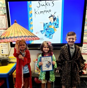 first grade students trying on Japanese Kimonos