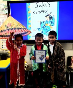 first grade students trying on Japanese Kimonos