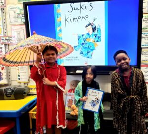 first grade students trying on Japanese Kimonos