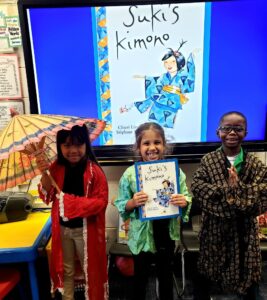 first grade students trying on Japanese Kimonos