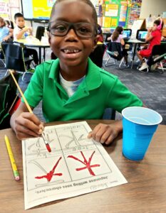 Students painting Japanese characters