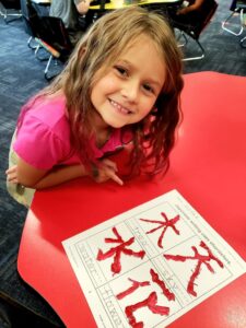 Students painting Japanese characters