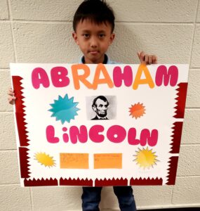 1st grader presenting their famous American project