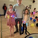 Father with his two daughters in the gym
