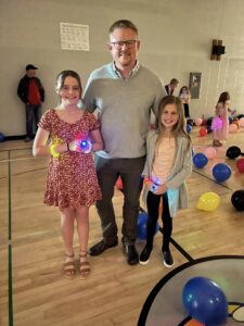 Father with his two daughters in the gym