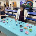 girls decorating cookies at the father-daughter dance