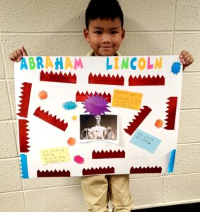 1st grader presenting their famous American project