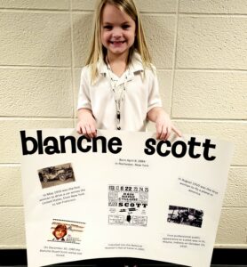 1st grader presenting their famous American project
