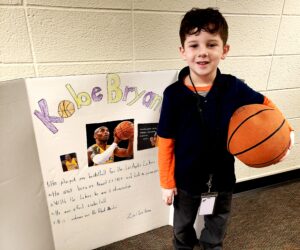 1st grader presenting their famous American project