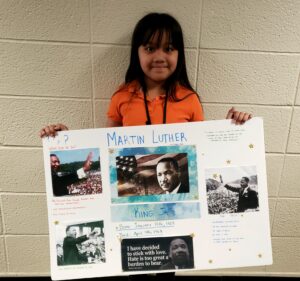 1st grader presenting their famous American project