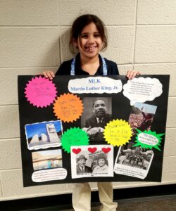 1st grader presenting their famous American project
