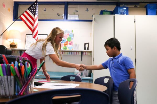 first grade student shaking hands with Mrs. White