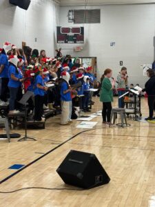 Choir singing at Cocoa and Carols event
