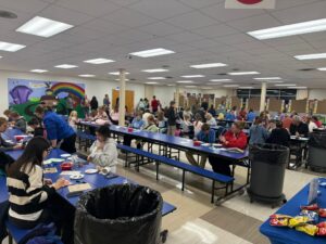 students and families painting ornaments