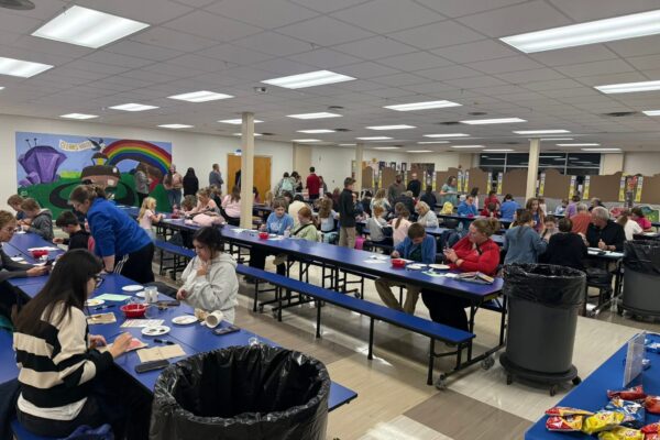 students and families painting ornaments