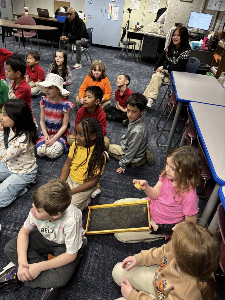second graders listening to a presentation about bees