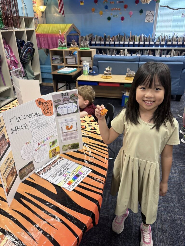 First grader presenting about what she learned about the cheetah and it's habitat