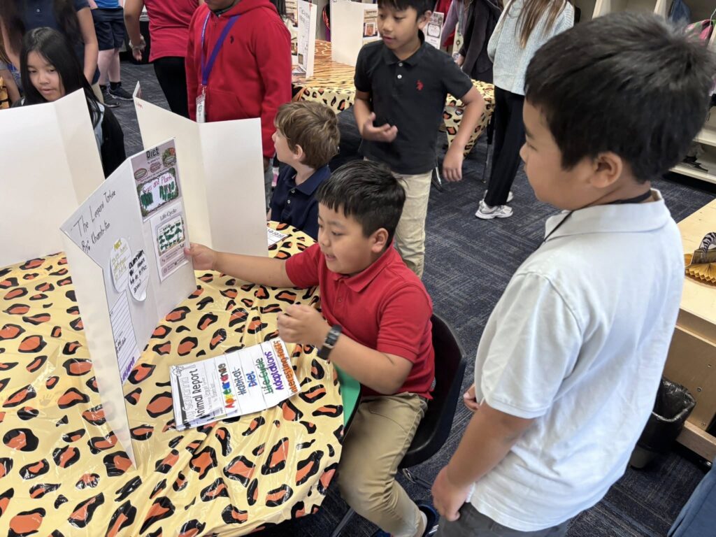 First grade students presenting about their habitats