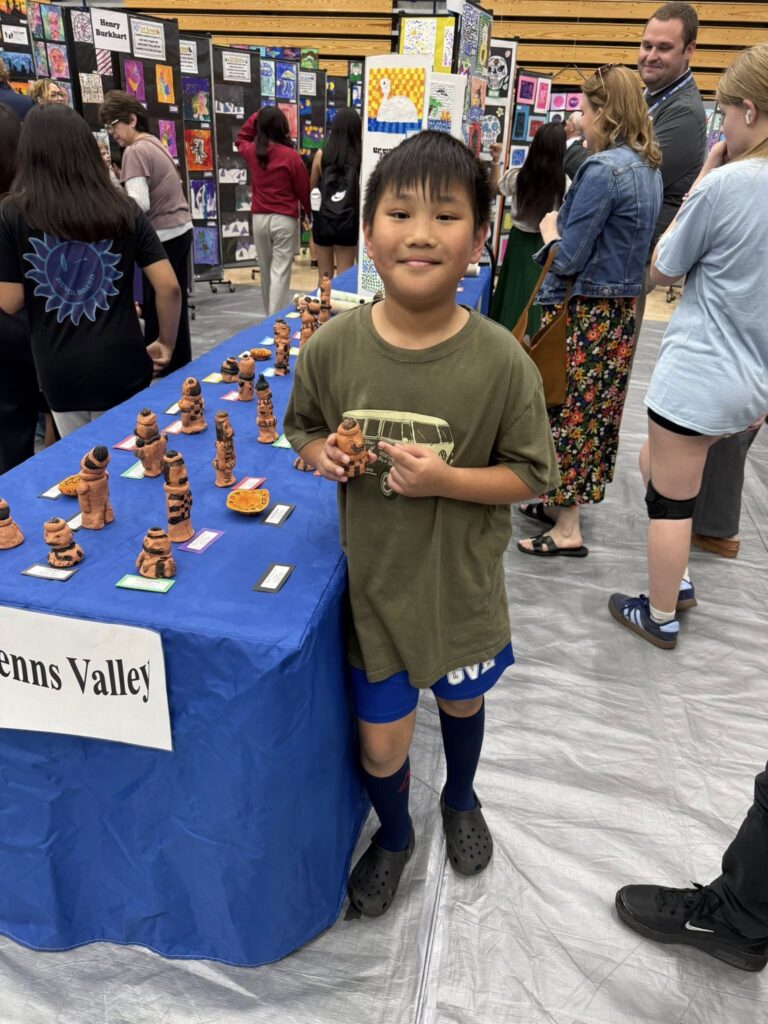 Student holding their Terracotta Warrior sculpture