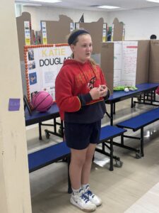 Student dressed as Katie Douglas and presenting at the wax museum