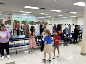 Fourth grade students presenting at their wax museum