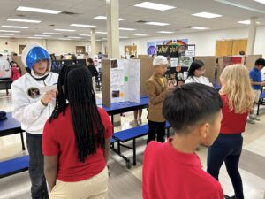 Fourth grade students presenting at their wax museum