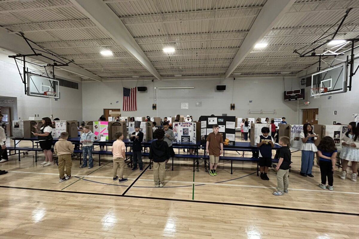 Fourth grade students presenting at their wax museum