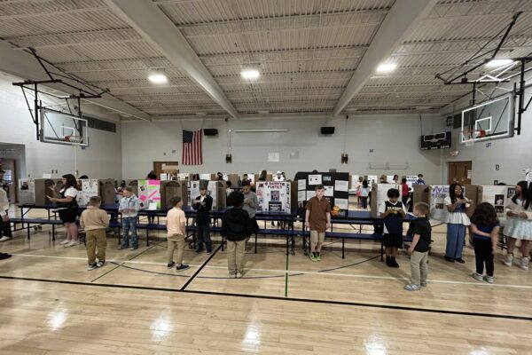 Fourth grade students presenting at their wax museum
