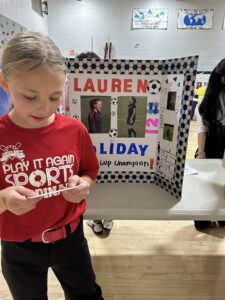 Student dressed as Lauren Holiday and presenting at the wax museum