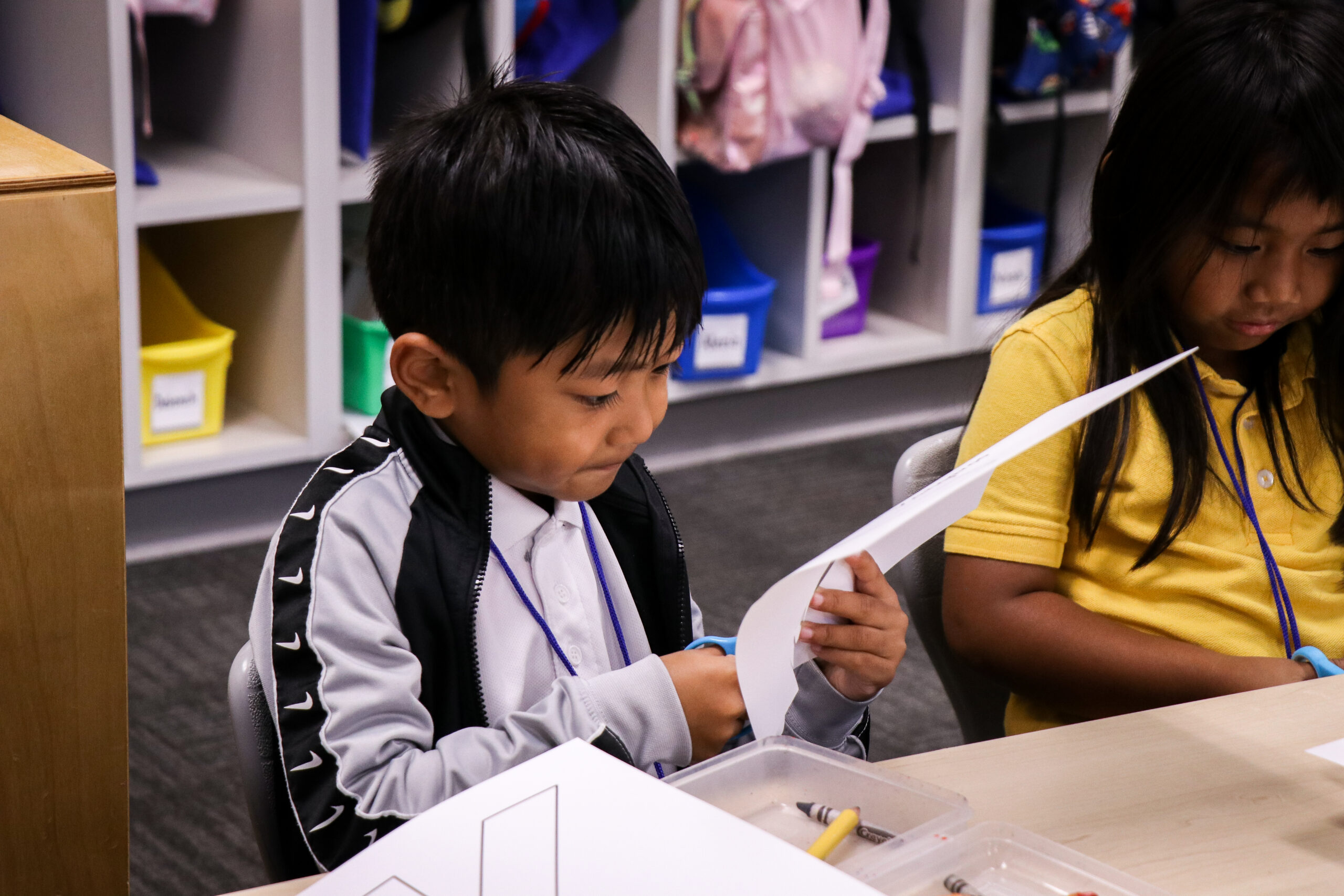 Two students working at a table.