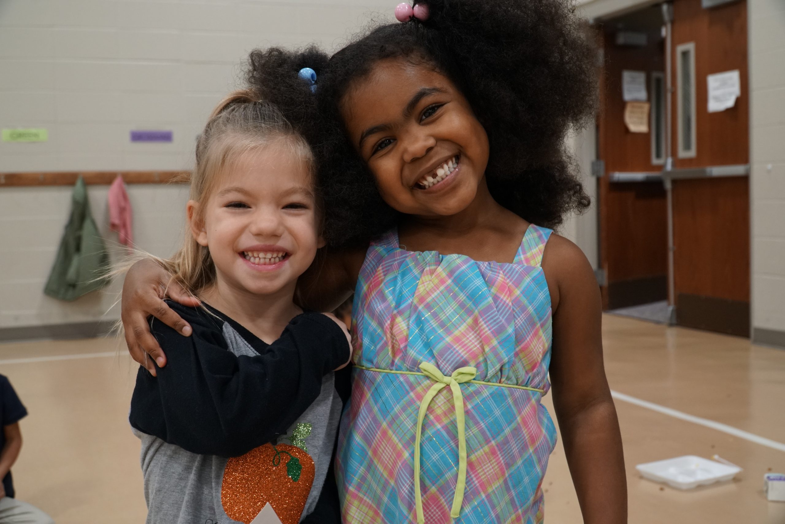 Two preschool girls hugging