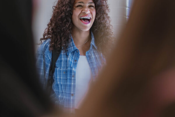 A student laughs while interacting with peers during filming on the University of Indianapolis campus for Perry Township Schools' Innovation & Entrepreneurship Program.