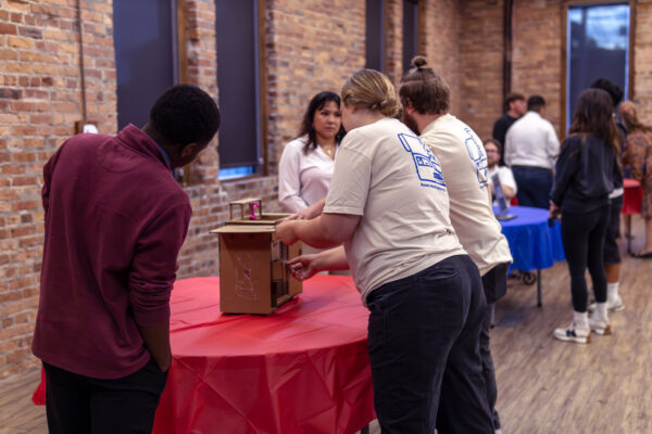 students meeting with business owners
